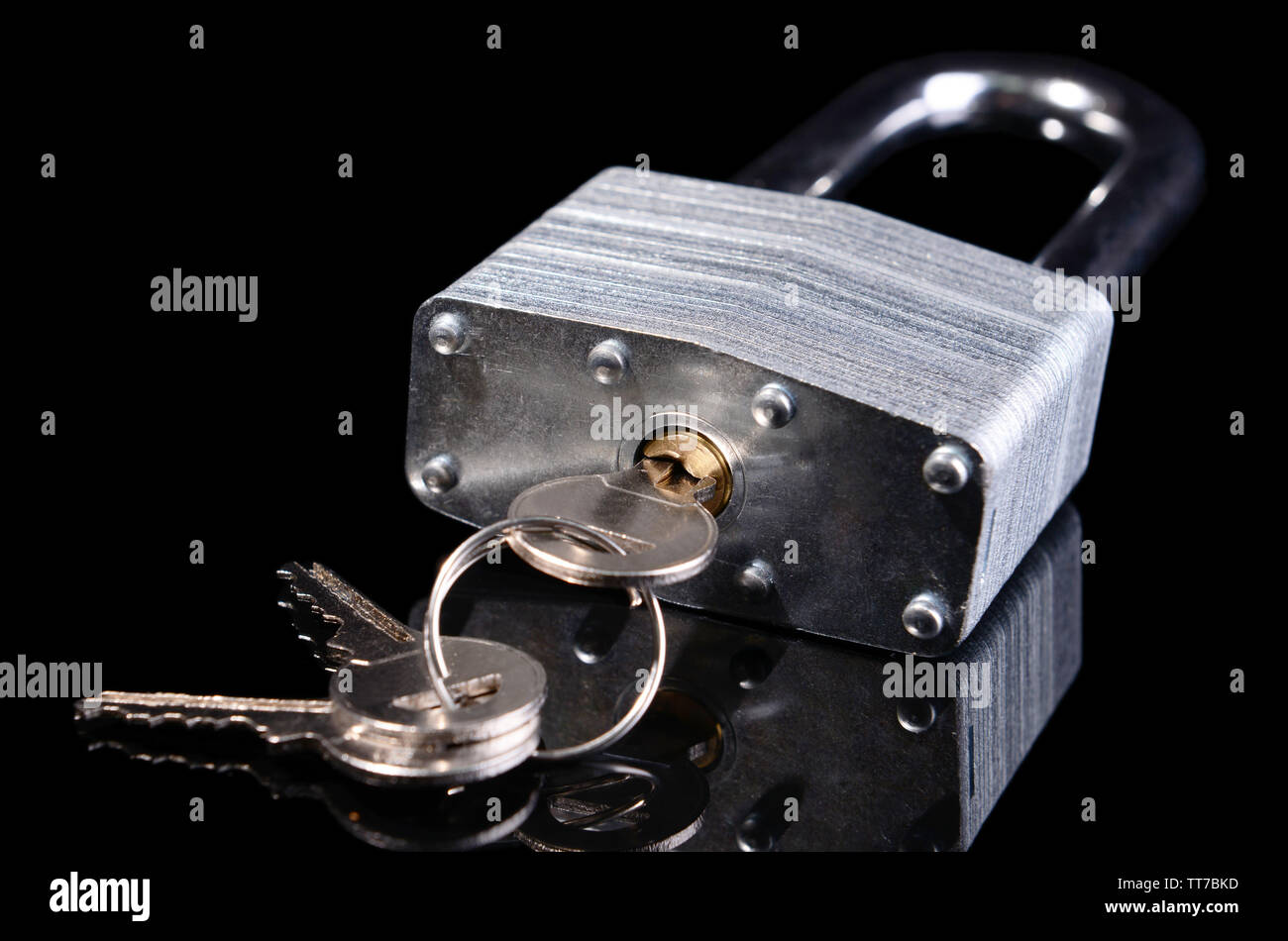 Padlock with keys isolated on black Stock Photo
