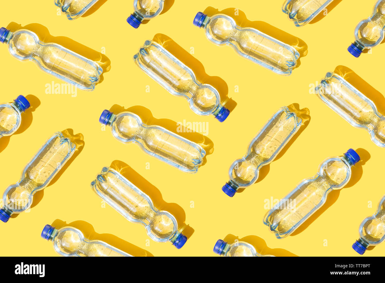 Mineral water bottles pattern on yellow background Stock Photo