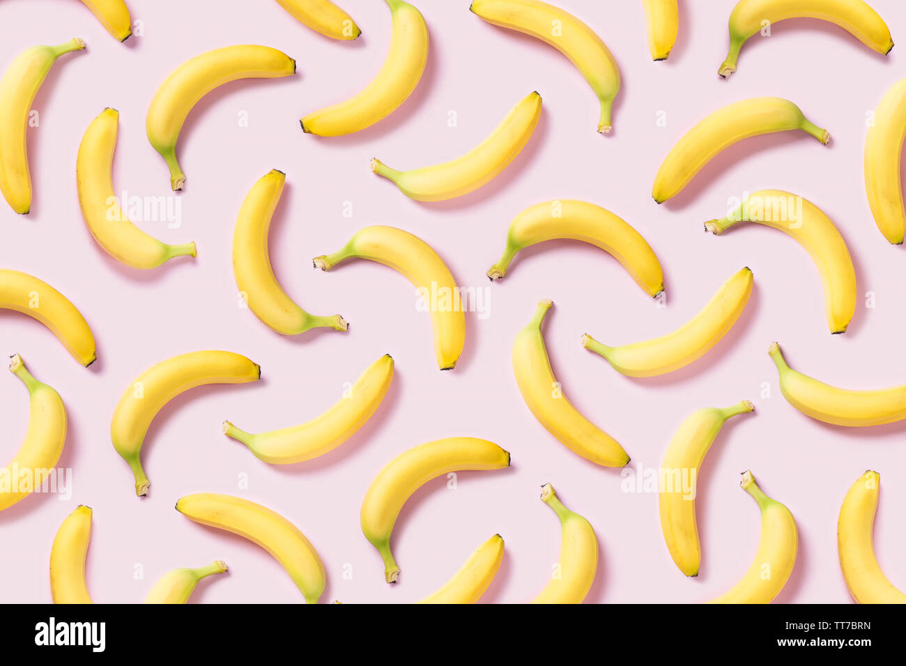 Yellow bananas pattern on pink background Stock Photo