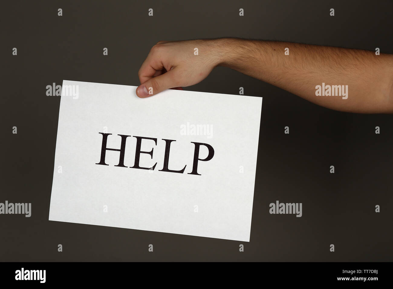 Send Help Handwritten Sign Sheet of paper with Help sign in male hand on dark background Stock ...