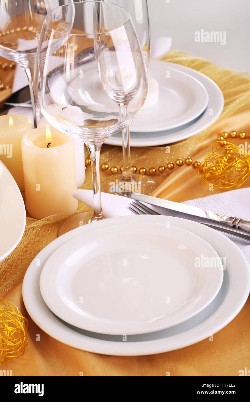 Beautiful holiday table setting in white and gold color Stock Photo - Alamy