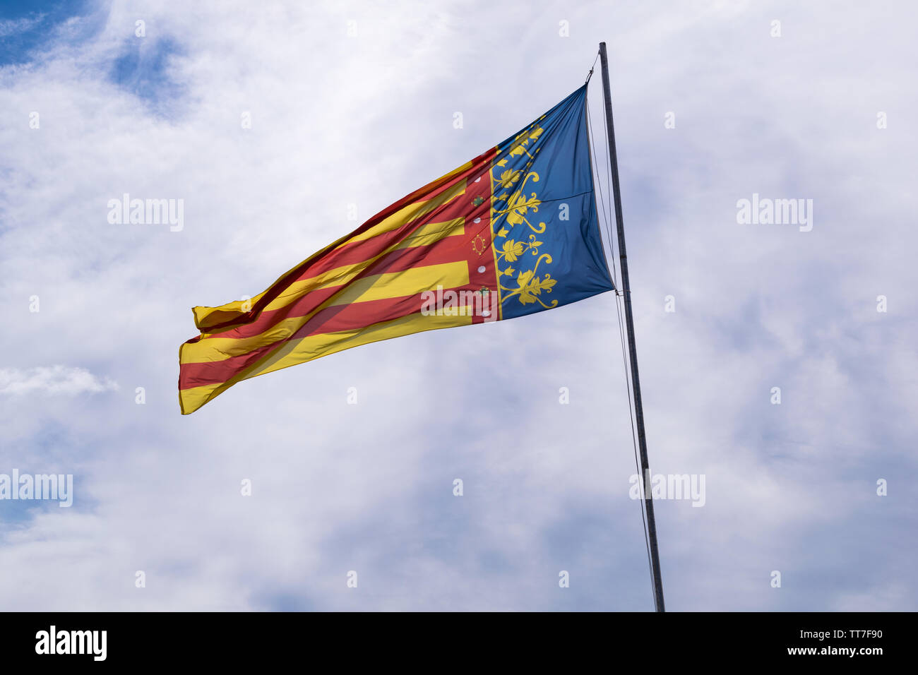 Valencian community flag waving in the wind with blue sky Stock Photo