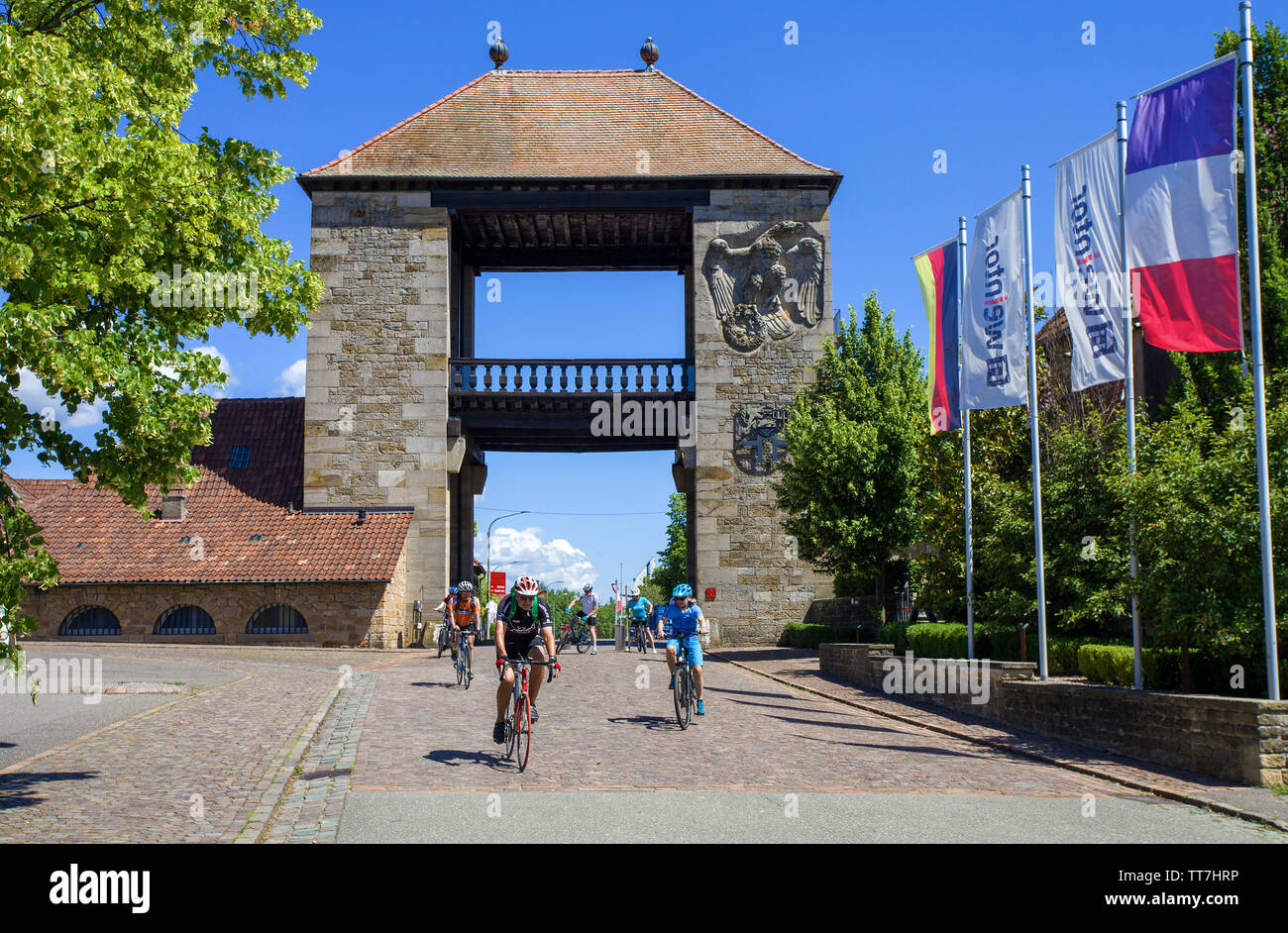Cyclist at the German Wine Gate (german: Deutsches Weintor), beginning of the German Wine Route, Schweigen-Rechtenbach, Rhineland-Palatinate, Germany Stock Photo