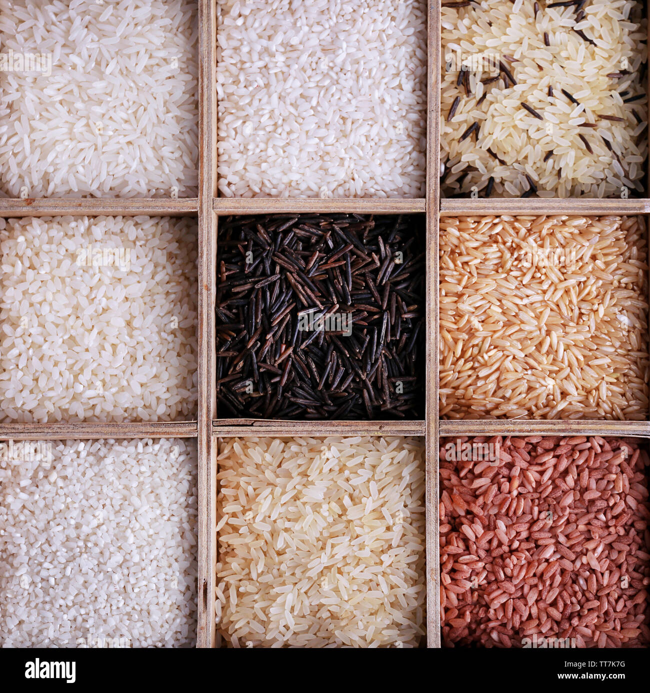 Individual Rice Options Different types of rice in box on wooden background Stock Photo - Alamy