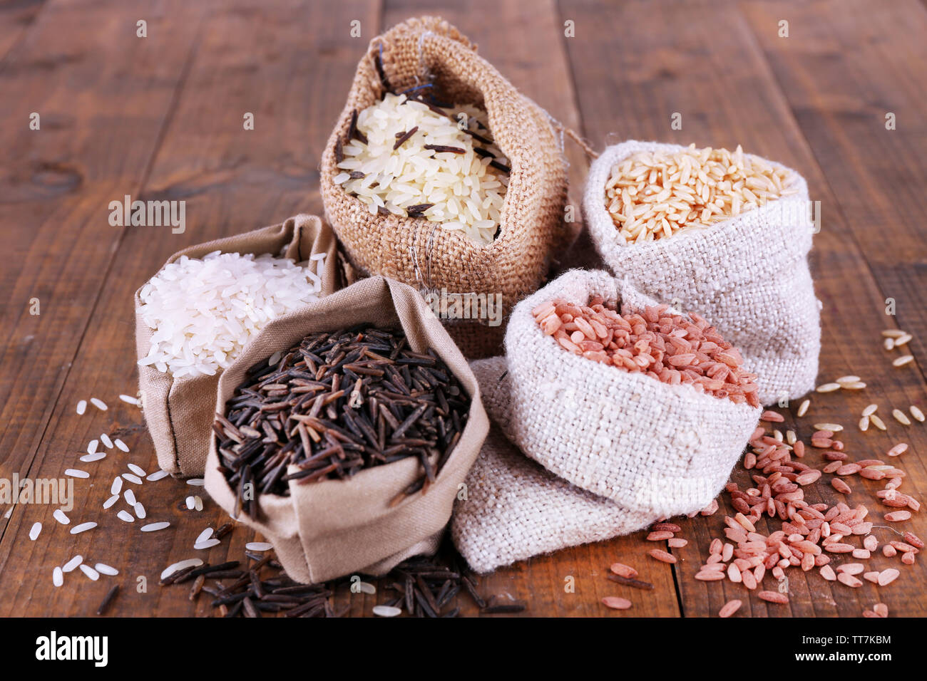 Types Rice Stocking Different types of rice in sacks on wooden background Stock Photo - Alamy