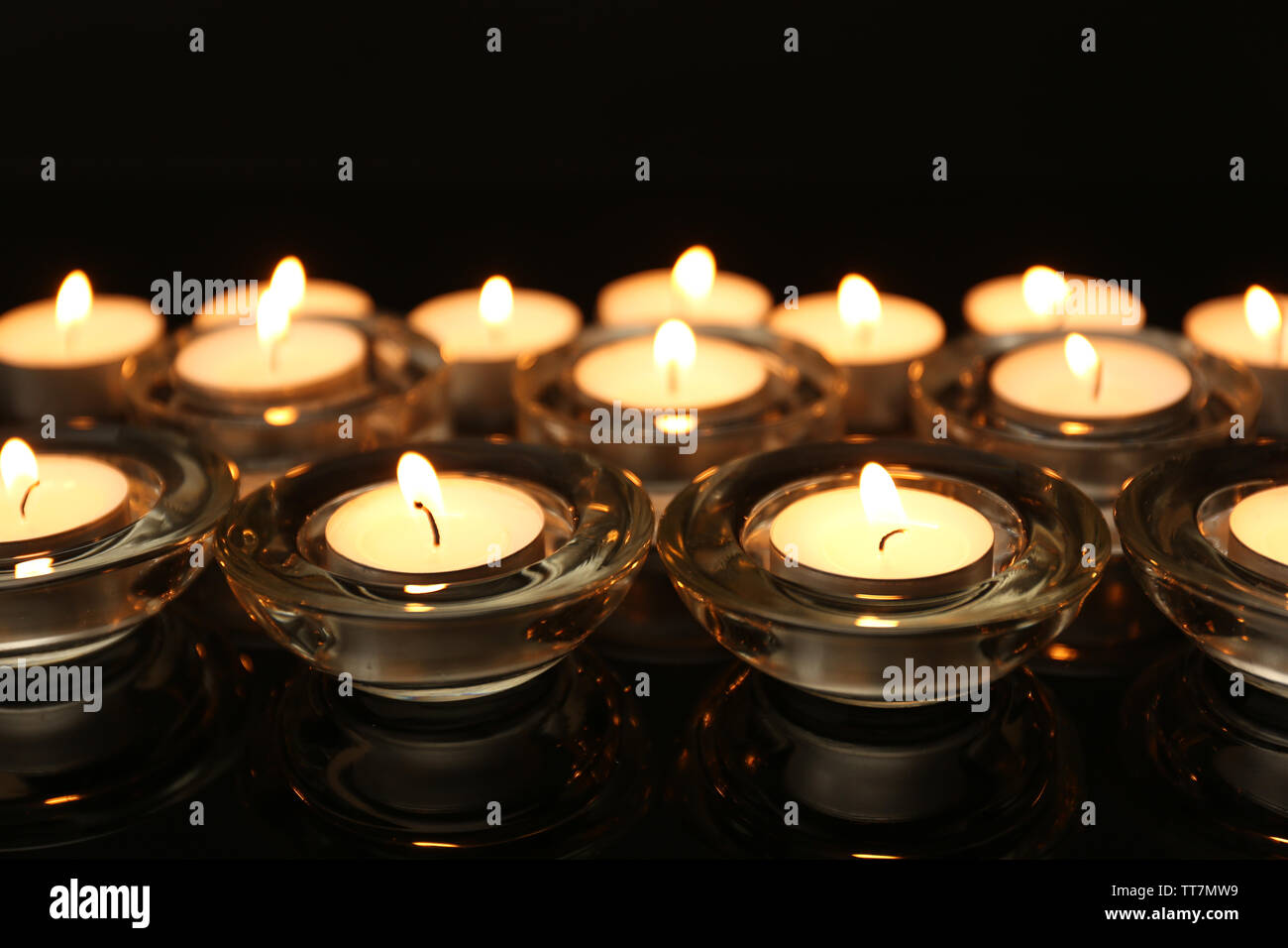 Burning candles on dark background Stock Photo - Alamy