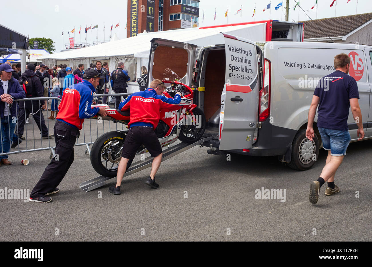 Members of the Honda team load a bike into the back of a van after the Senior TT race in 2019 Stock Photo