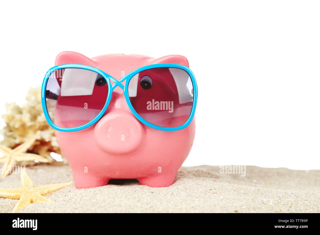 Piggy bank with sunglasses on sand, on white background Stock Photo - Alamy