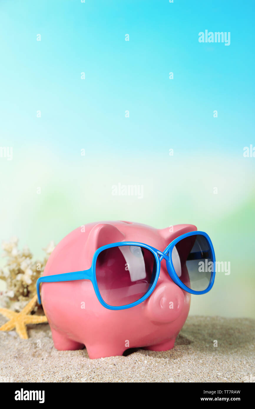 Piggy bank with sunglasses on the beach Stock Photo - Alamy