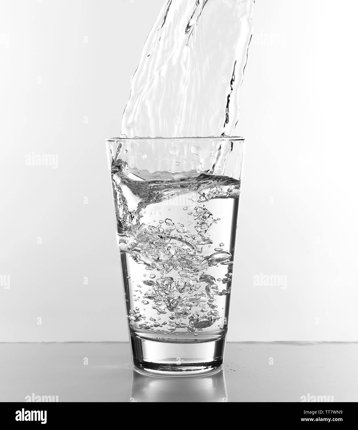 Water pouring in glass isolated on white Stock Photo Alamy