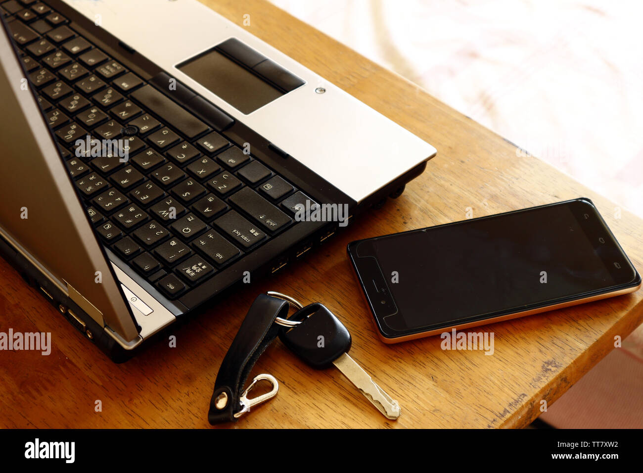 Photo Of A Laptop Computer Car Key And Smartphone On A Table