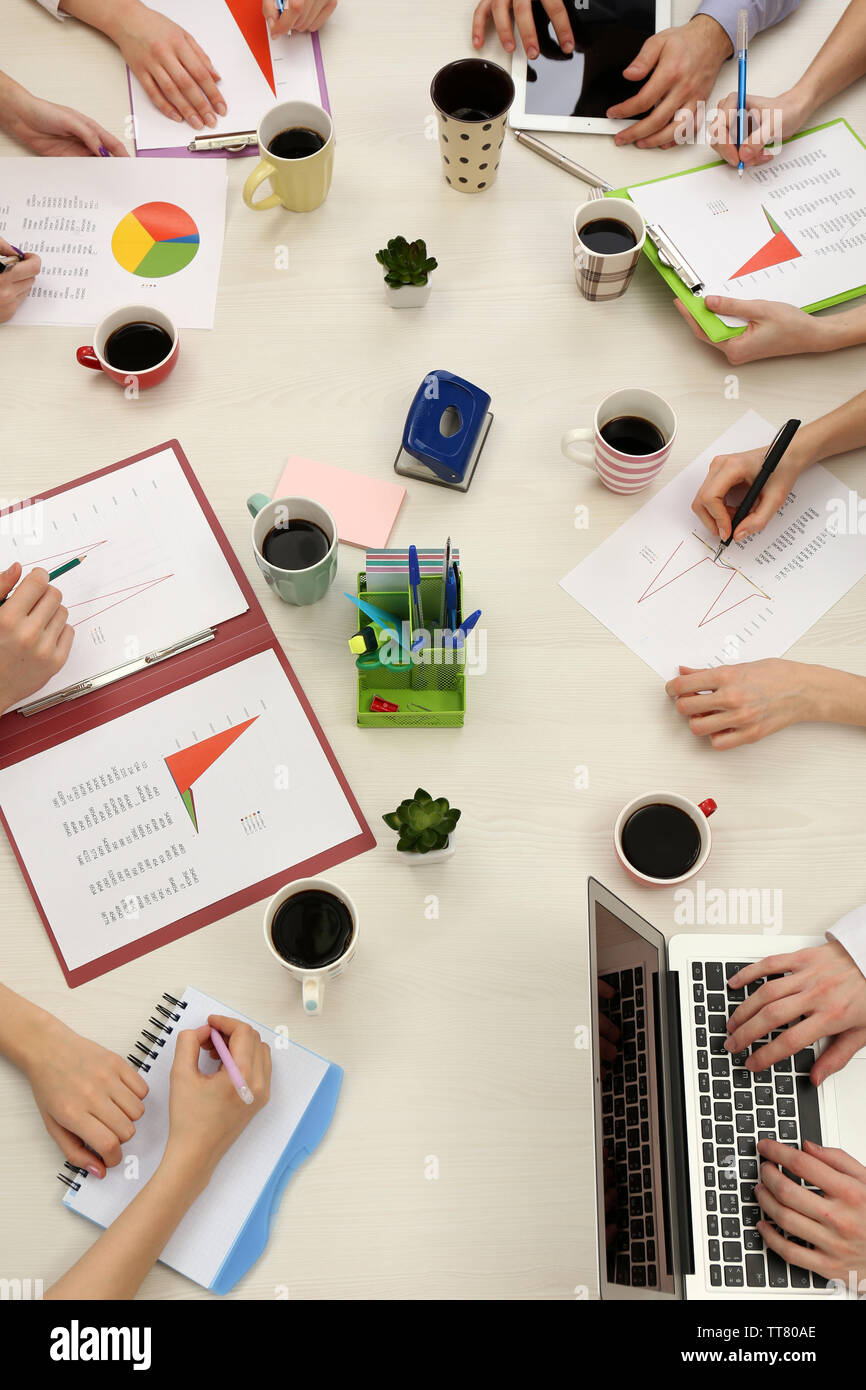 Group of business people working at desk top view Stock Photo - Alamy