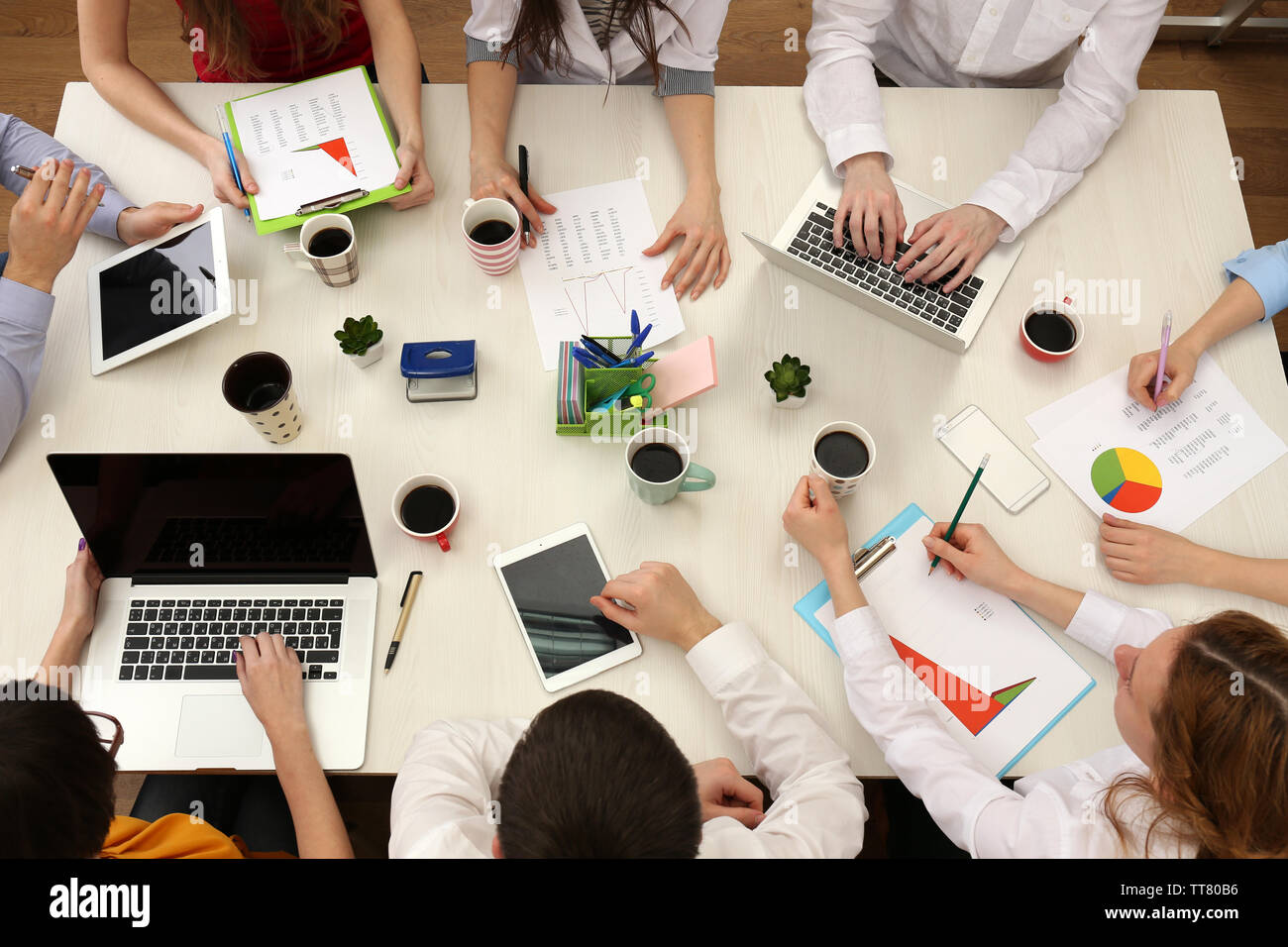 Group of business people working at desk top view Stock Photo - Alamy