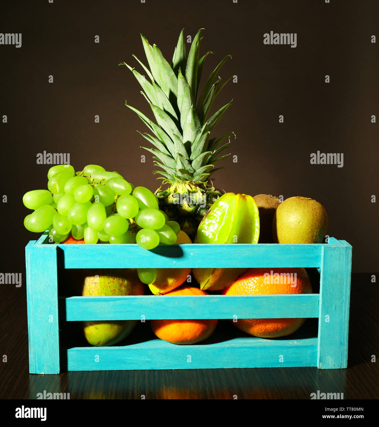 Assortment of fruits in box on dark background Stock Photo - Alamy