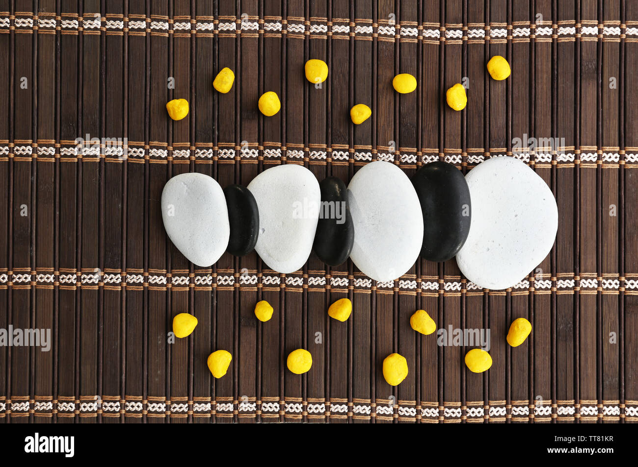 Spa stones on bamboo mat Stock Photo - Alamy