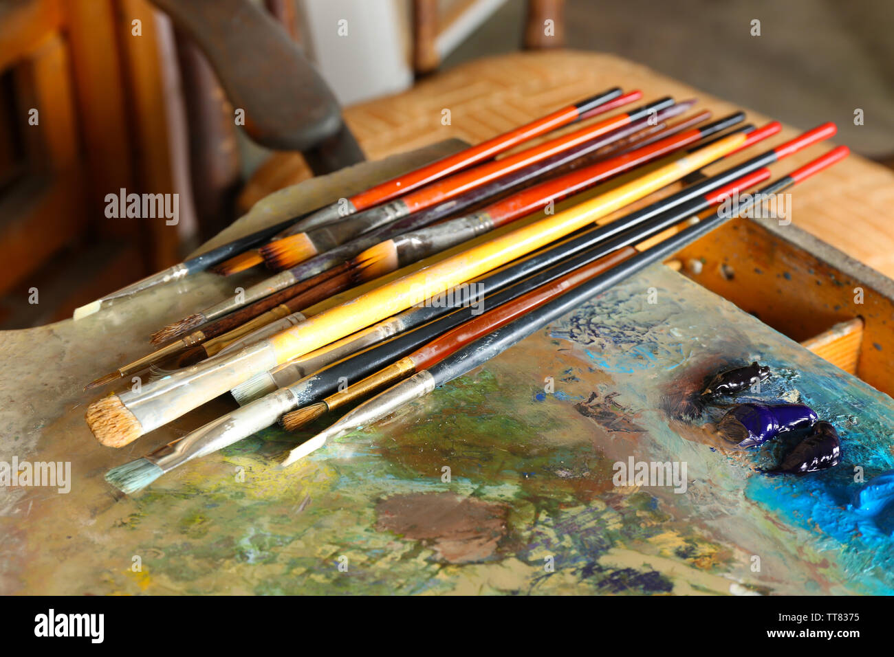 Acrylic paint with brushes on wooden palette Stock Photo Alamy
