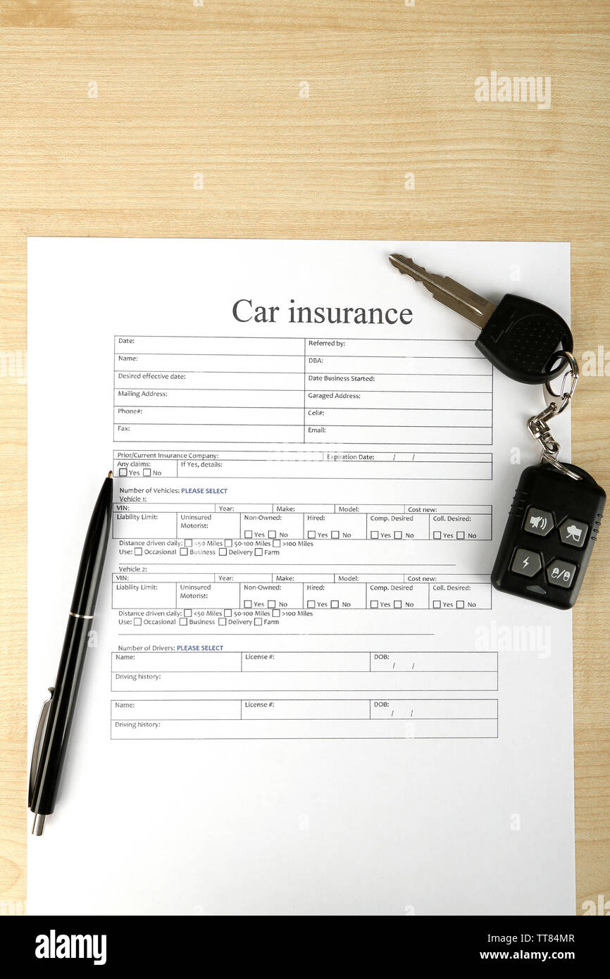Car keys on insurance documents, close up Stock Photo Alamy