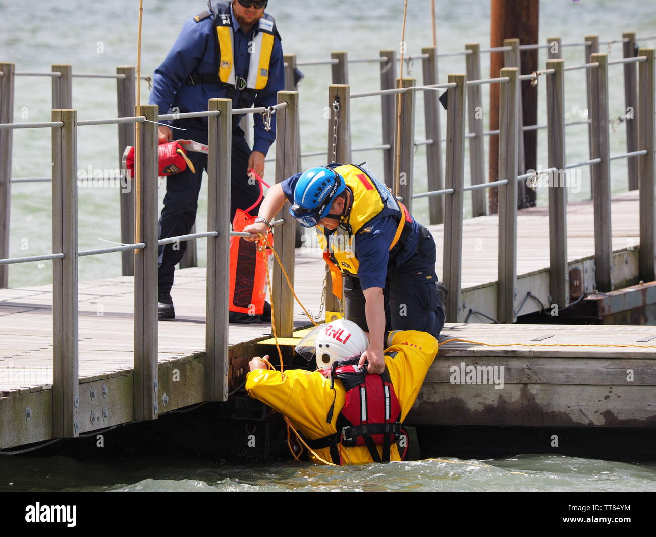 Queenborough, Kent, UK. 15th June, 2019. Sheerness RNLI held an Open Day in Queenborough Habour, Kent this day with various demonstrations. A volunteer is rescued from the water using a throw line from a Coastguard officer. Credit: James Bell/Alamy Live News Stock Photo