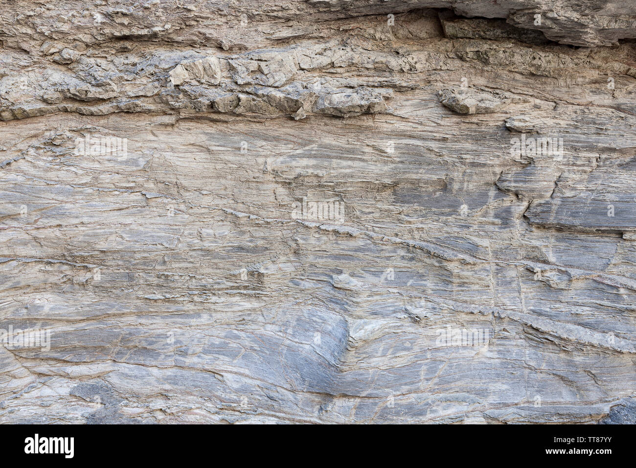 Natural texture of the rock surface, where you can see the lines drawn in the long rock of time. Can be used as background. Stock Photo