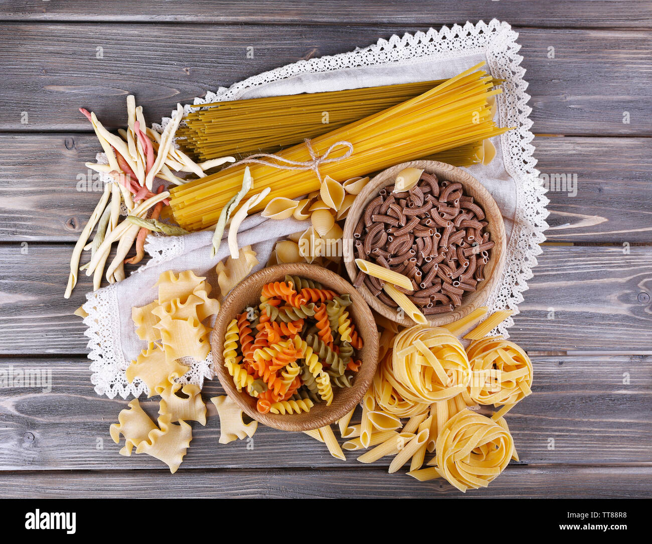 Different types of pasta on wooden planks background Stock Photo - Alamy