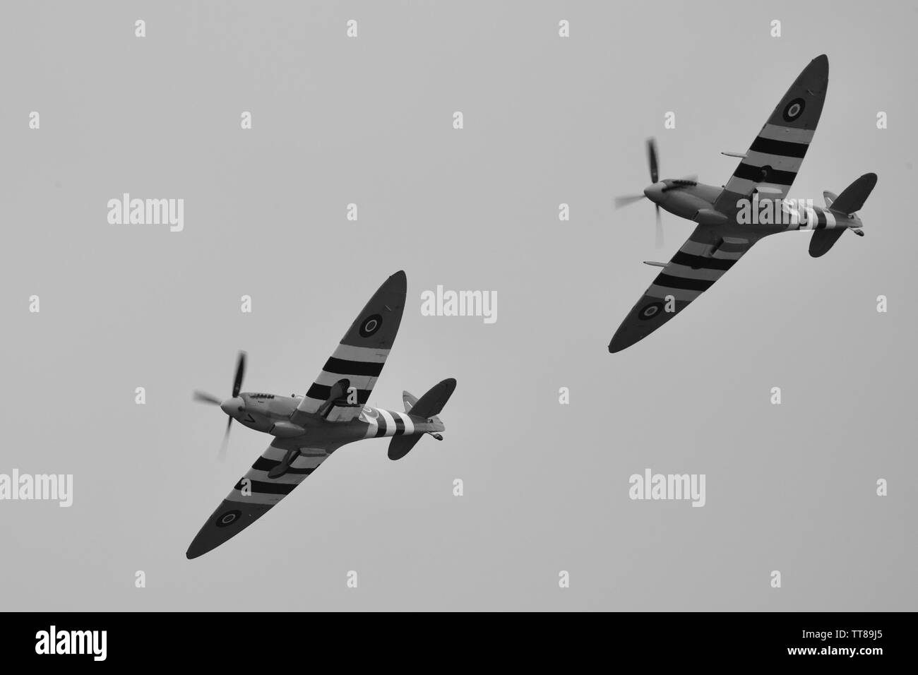 Daks over Normandy - 2 Supermarine Spitfires flying in formation to commemorate the 75th anniversary of D-Day at the IWM Duxford on the 4th June 2019 Stock Photo