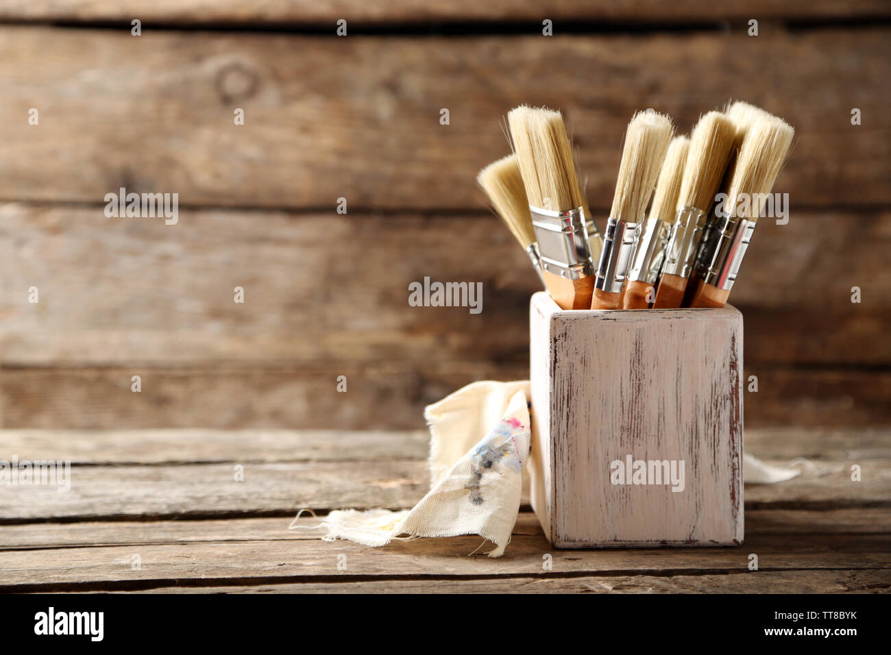 Paint brushes on old wooden background Stock Photo - Alamy