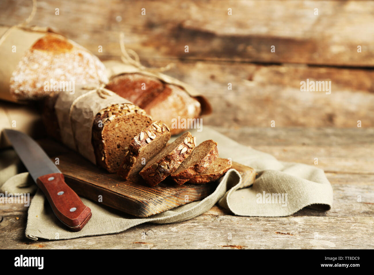 Different fresh bread, on old wooden table Stock Photo - Alamy