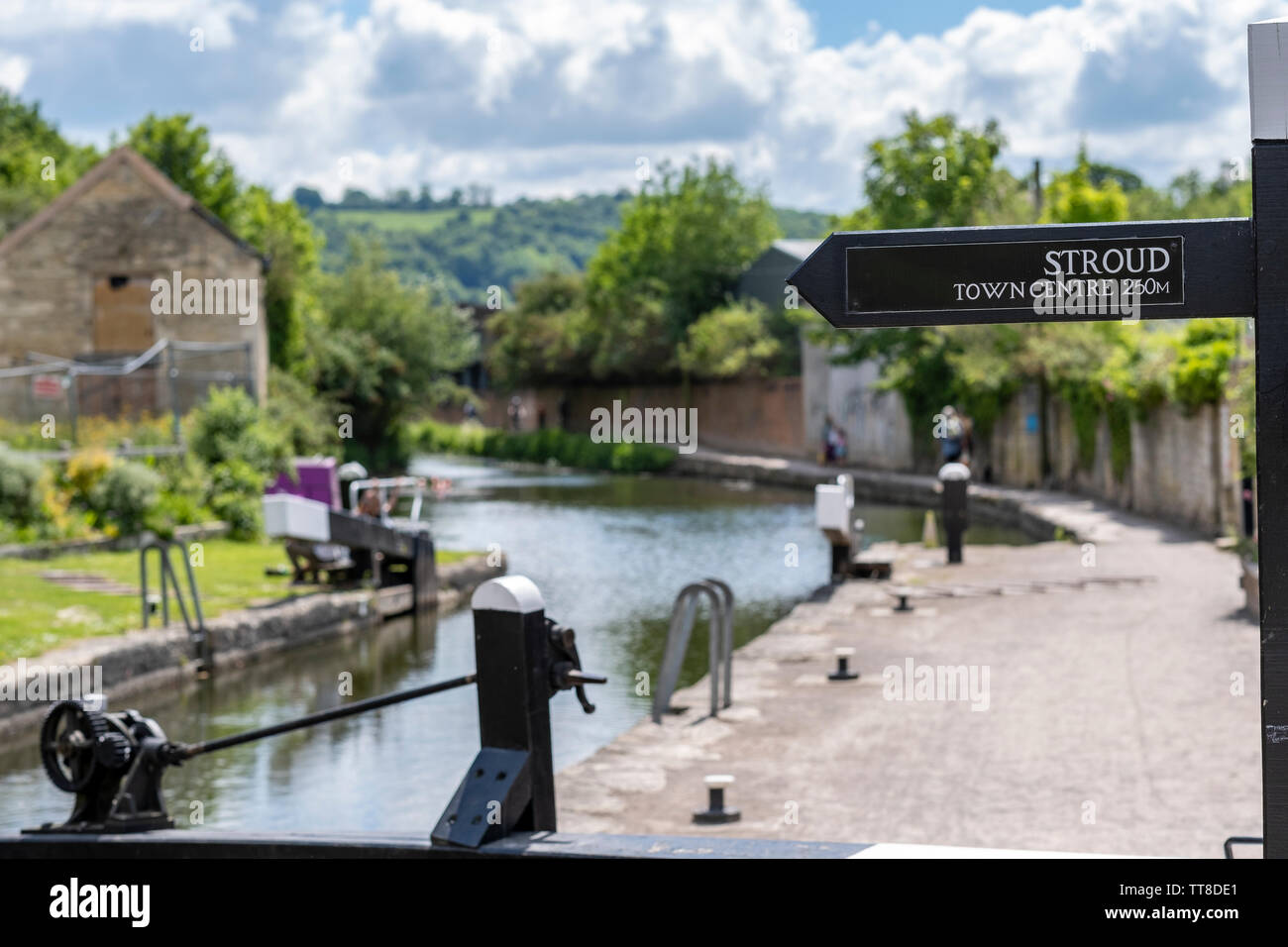 Thames and Severn canal and footpath on sunny day with sign for Stroud town centre. Stroud, Gloucestershire, United Kingdom Stock Photo