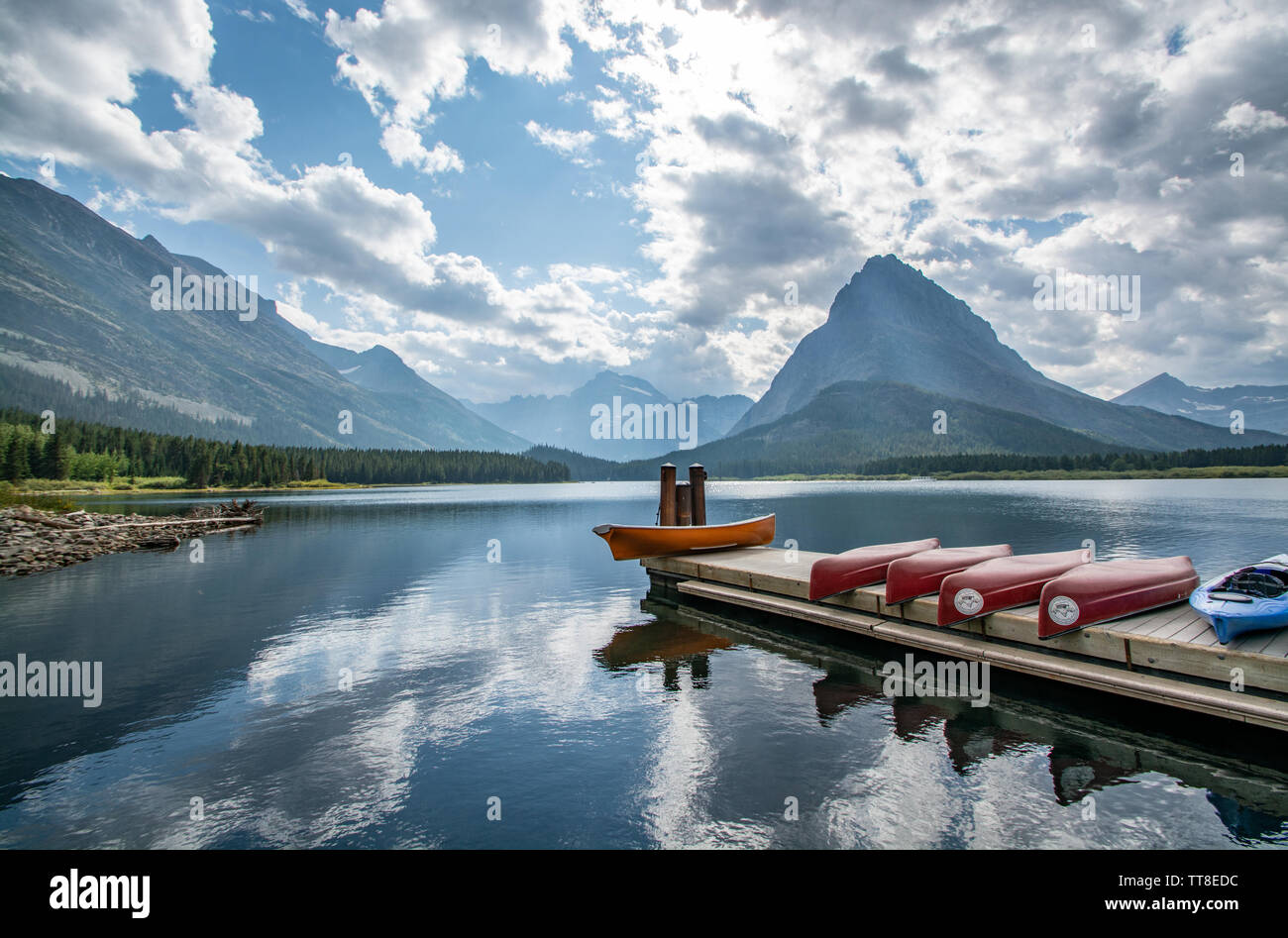 September 1, 2018, Canoes on Swift Current Lake, Reflections, Glacier National Park, Montana Stock Photo