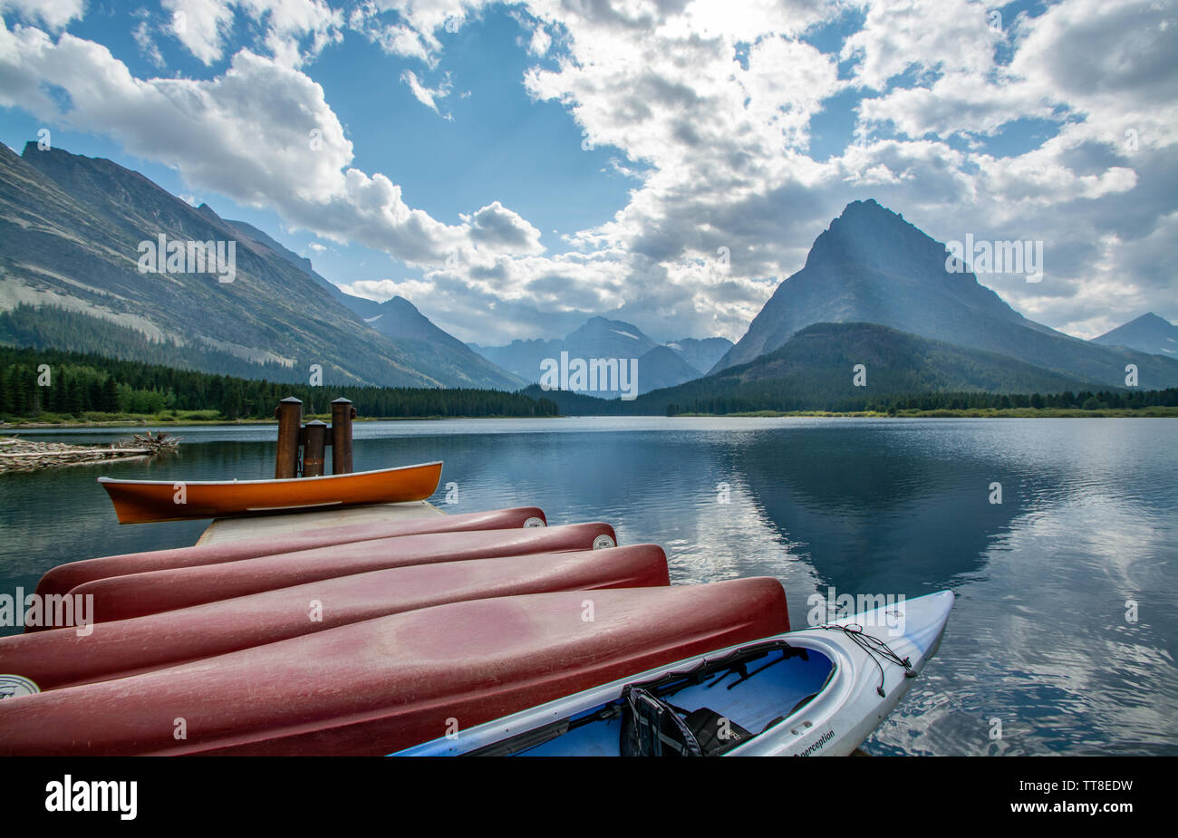 September 1, 2018, Canoes on Swift Current Lake, Reflections, Glacier National Park, Montana Stock Photo