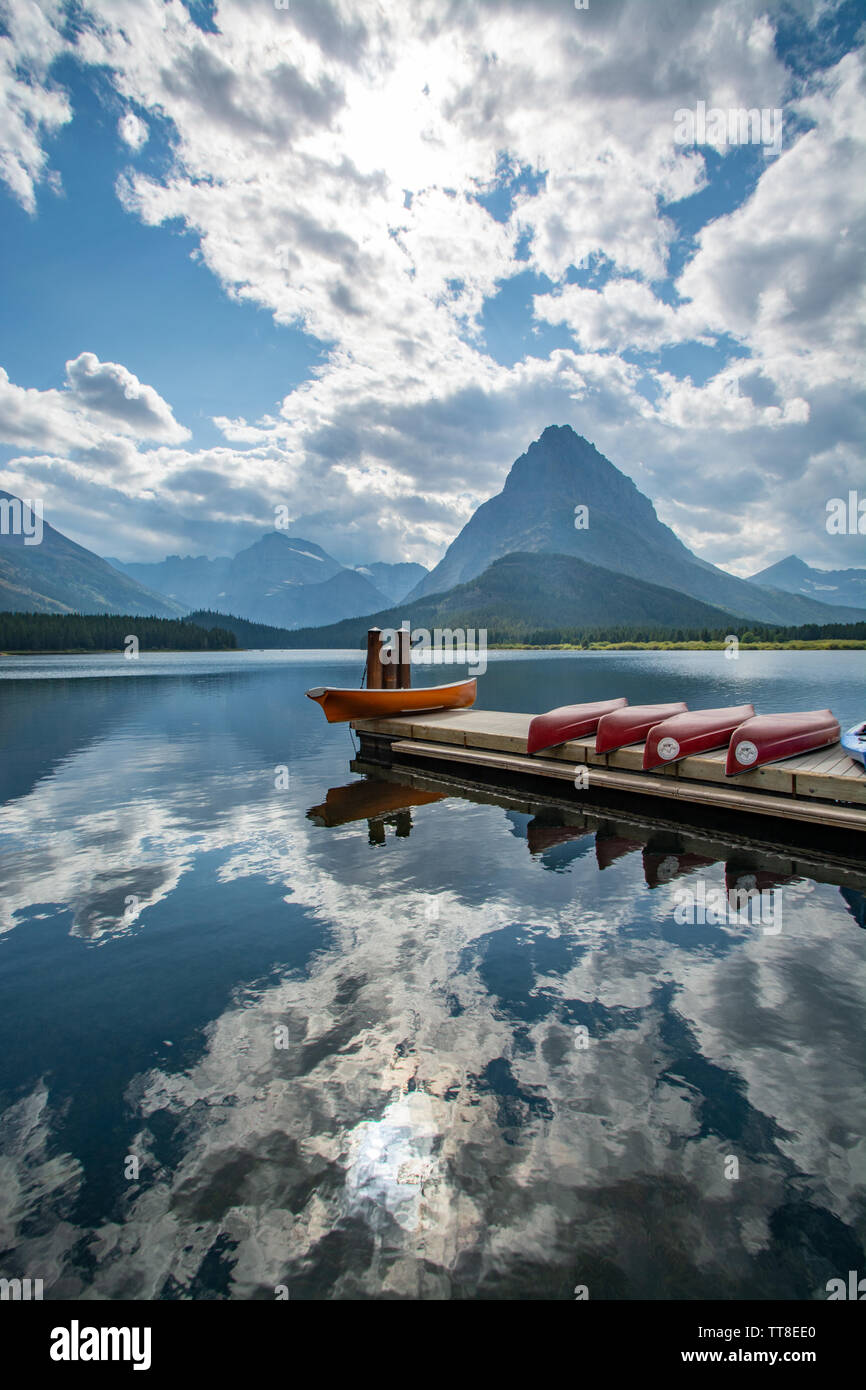 September 1, 2018, Canoes on Swift Current Lake, Reflections, Glacier National Park, Montana Stock Photo