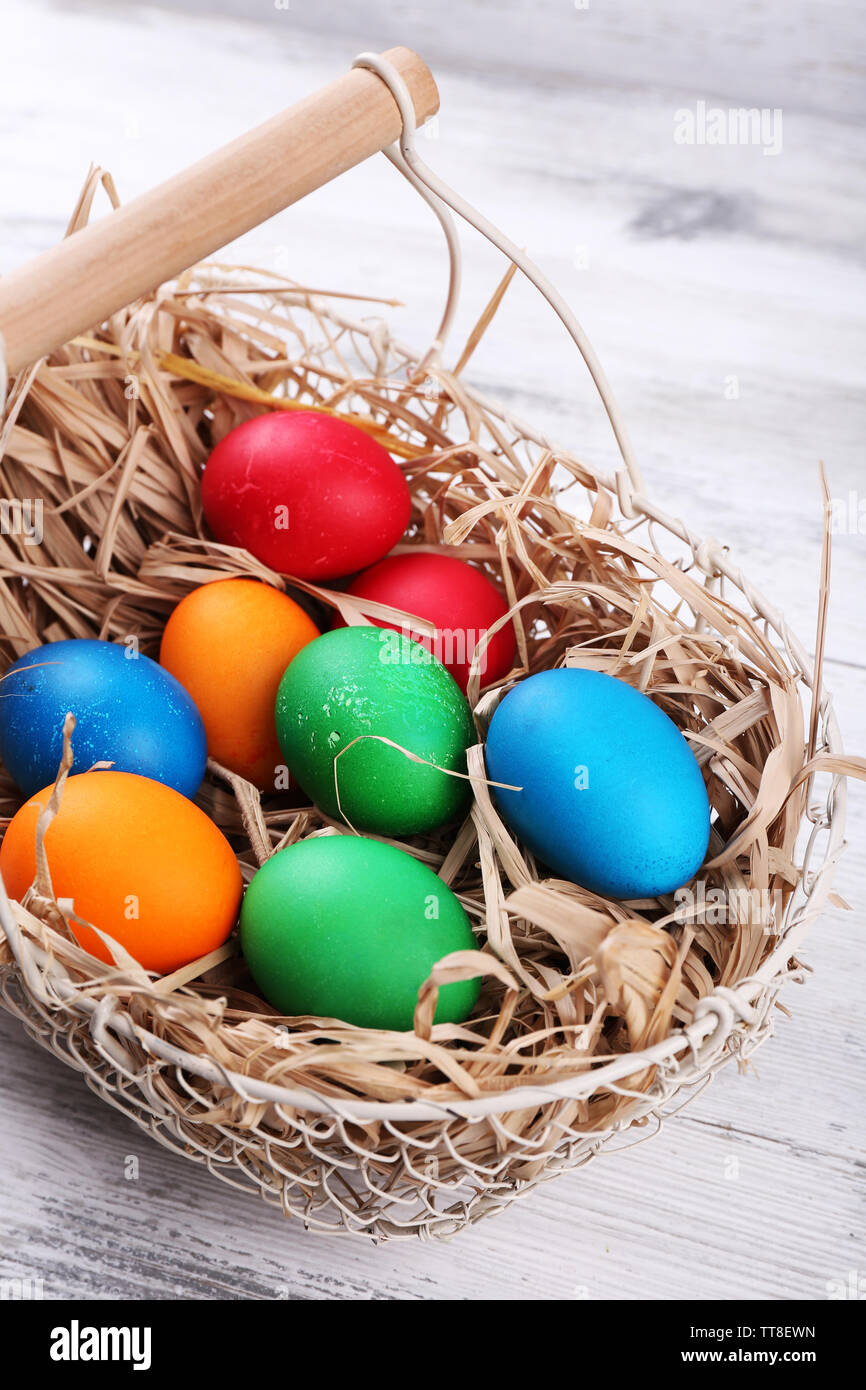 Easter eggs in basket on vintage wooden planks background Stock Photo ...