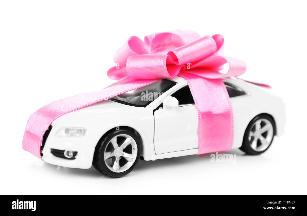 New car with pink bow as present isolated on white Stock Photo Alamy