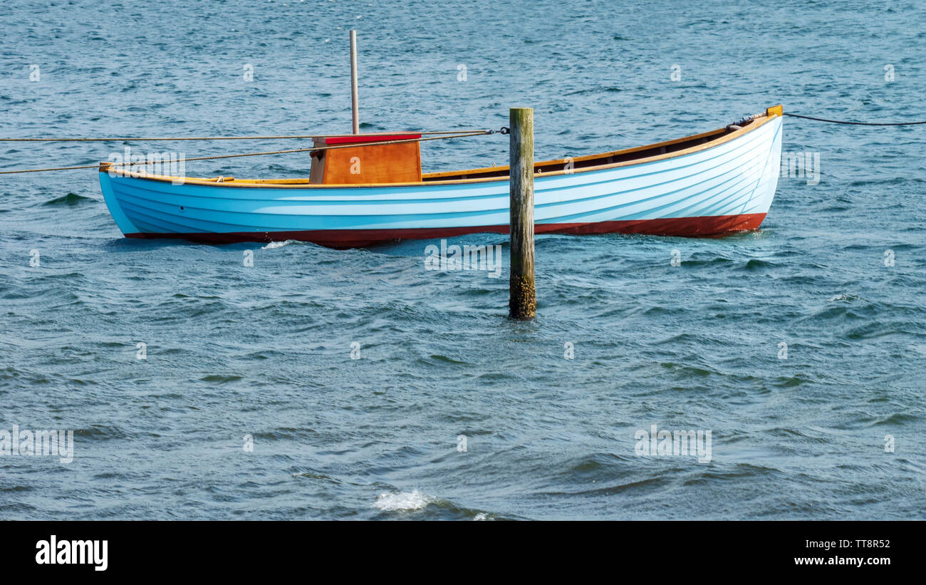 Fishing boat tethered to post in baltic sea horizontal panorama Stock Photo