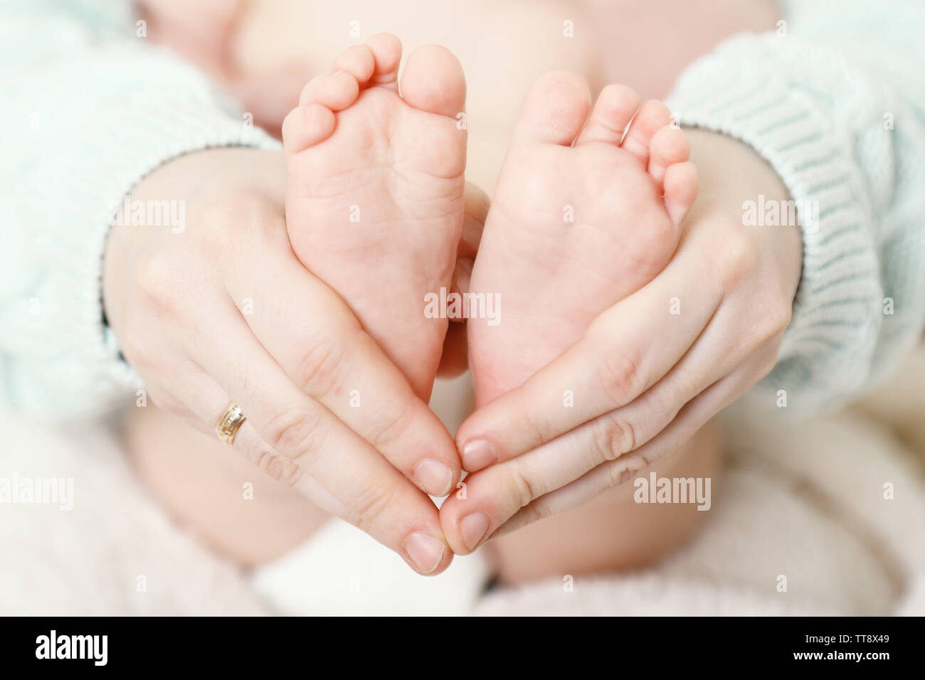 Newborn baby feet on female hands, closeup Stock Photo Alamy