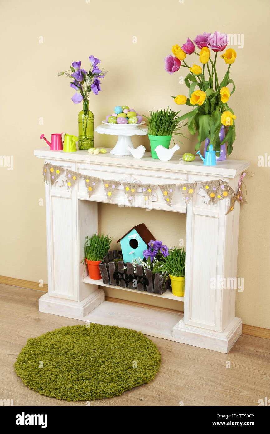 Fireplace with beautiful spring decorations in room Stock Photo - Alamy