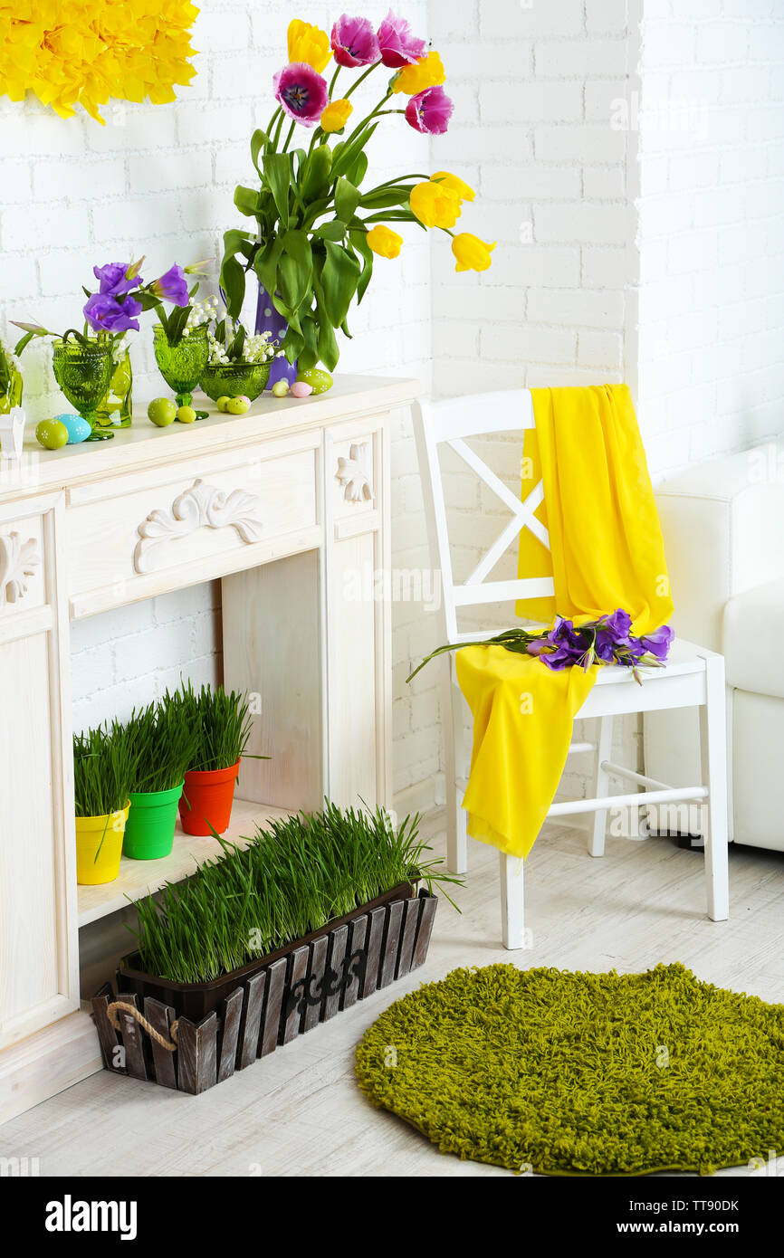 Fireplace With Beautiful Spring Decorations In Room Stock Photo