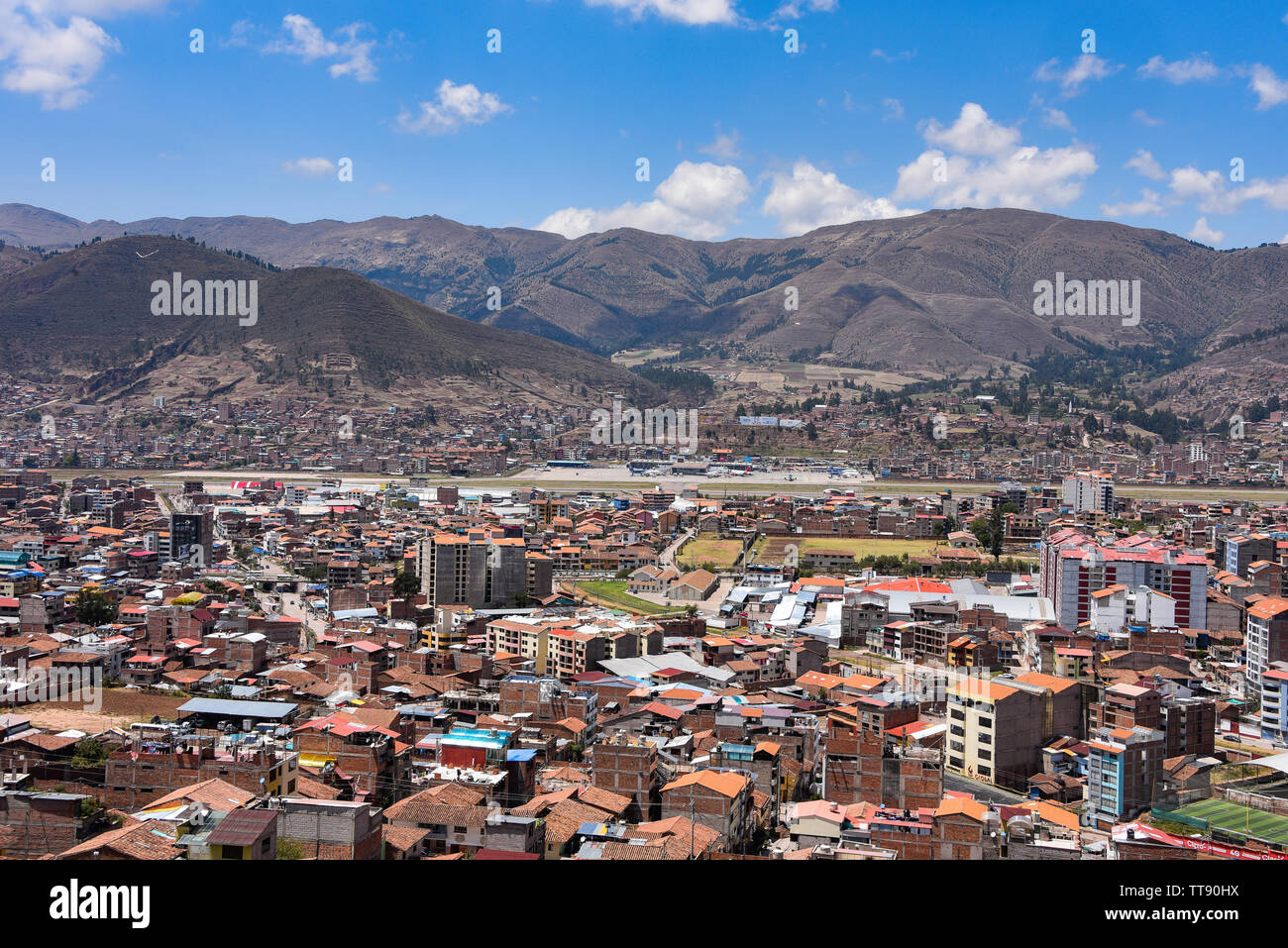 Views of Cusco airport and the San Sebastien district from Rumiwasi. Cusco, Peru Stock Photo