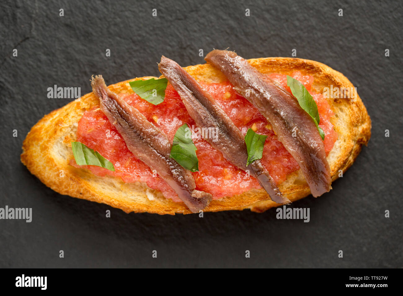 An example of Bruschetta which is an Italian dish comprising of grilled bread, olive oil and garlic with various toppings. In this case the bread has Stock Photo