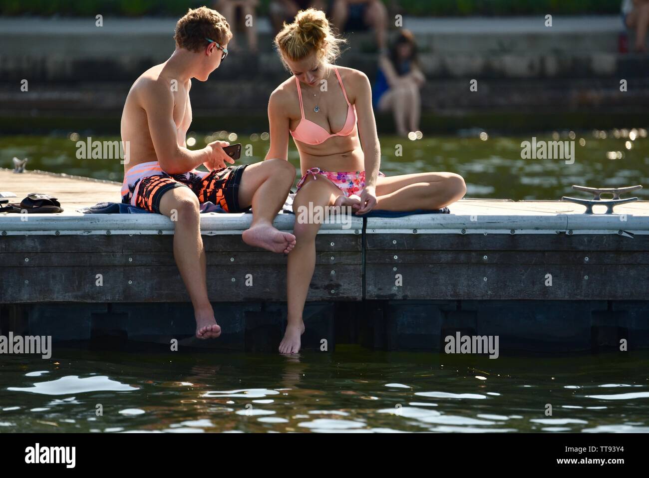 Young college students, male and female, in swimsuits, on dock, Lake Mendota, near University of Wisconsin Memorial Union, Madison, Wisconsin, USA Stock Photo