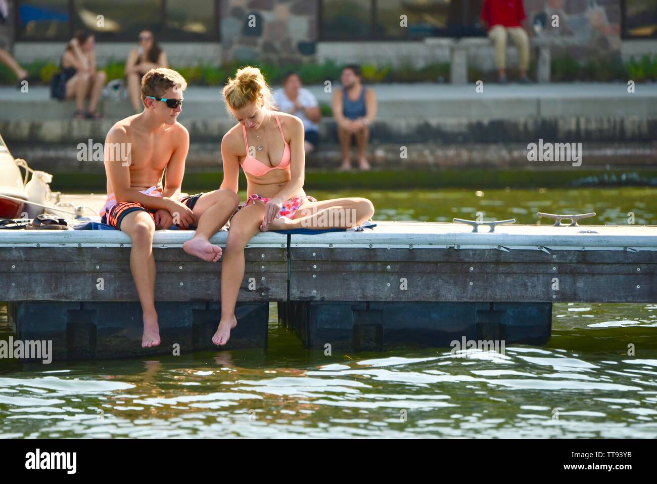 Young college students, male and female, in swimsuits, on dock, Lake Mendota, near University of Wisconsin Memorial Union, Madison, Wisconsin, USA Stock Photo
