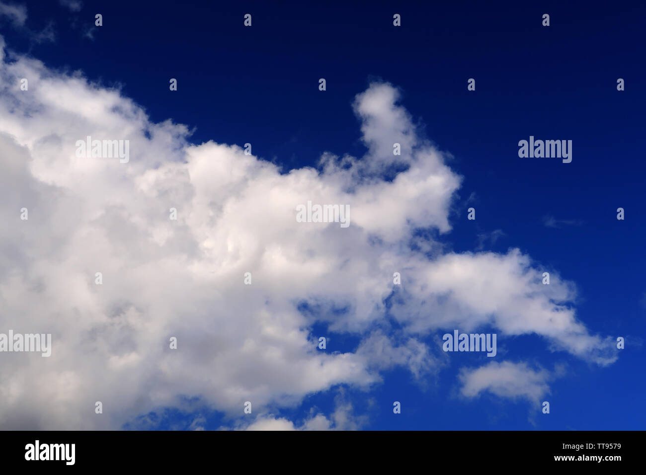 Whispy clouds spreading over a deep blue sky Stock Photo