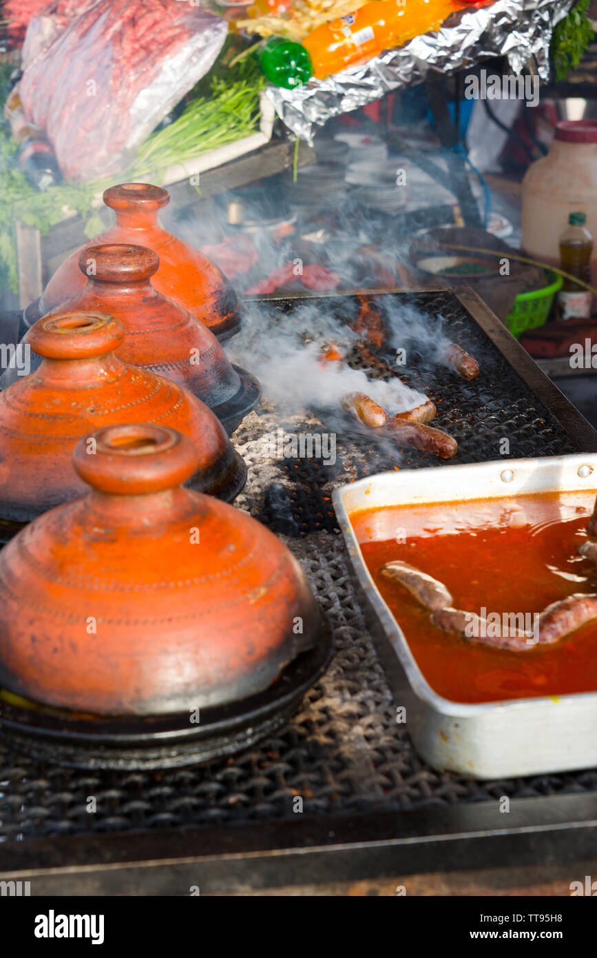 cooking in traditional moroccan tajine pot over open fire Stock Photo