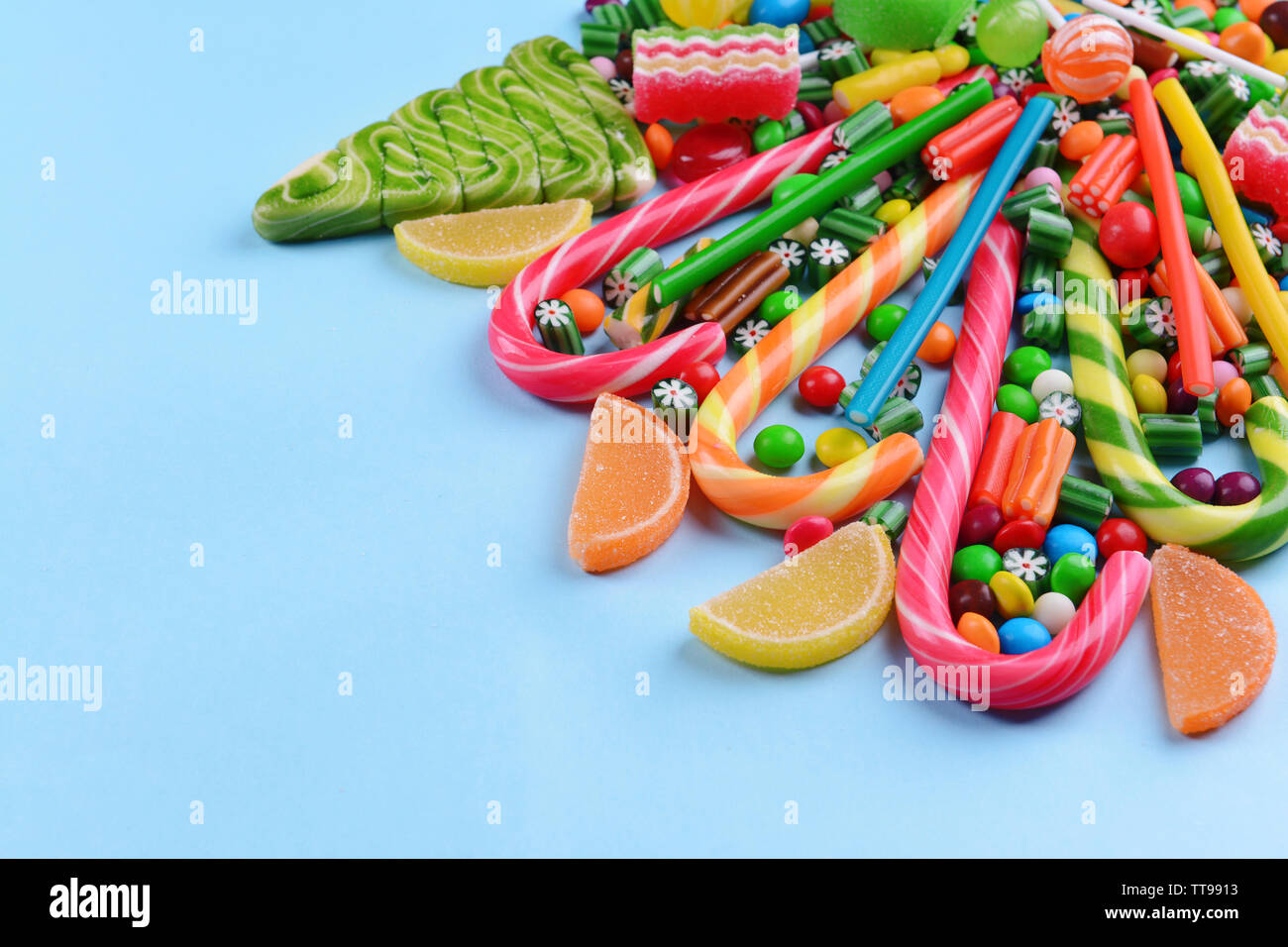 Colorful candies on light blue background Stock Photo - Alamy