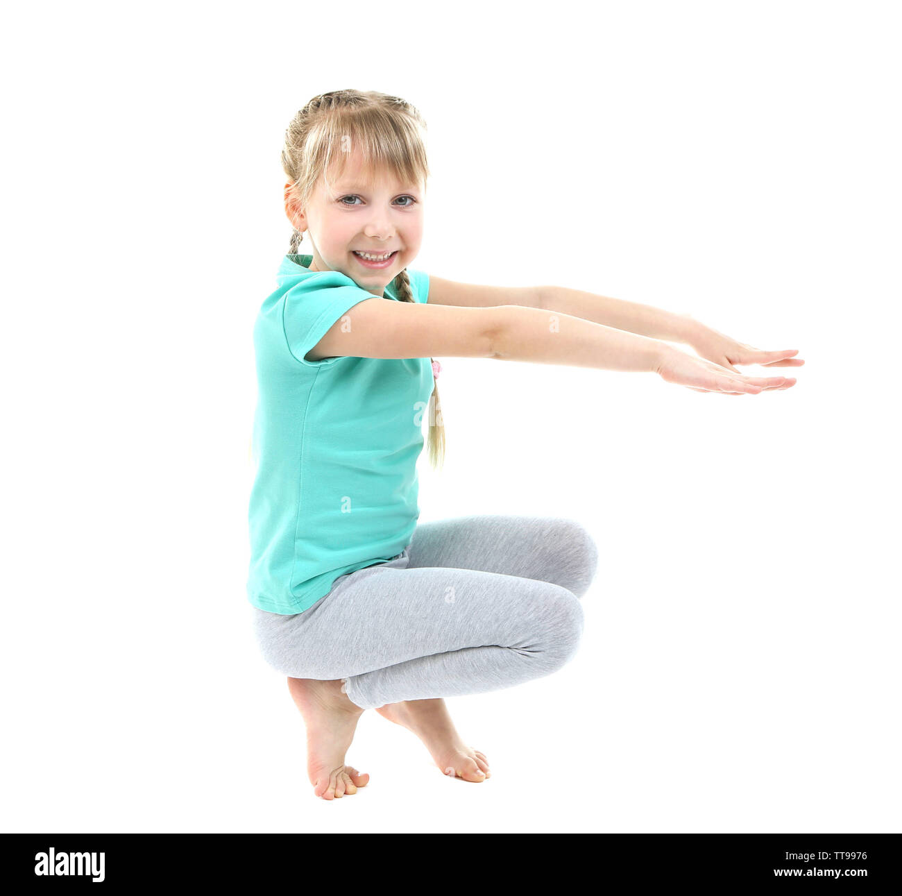 Little girl doing exercises isolated on white Stock Photo - Alamy