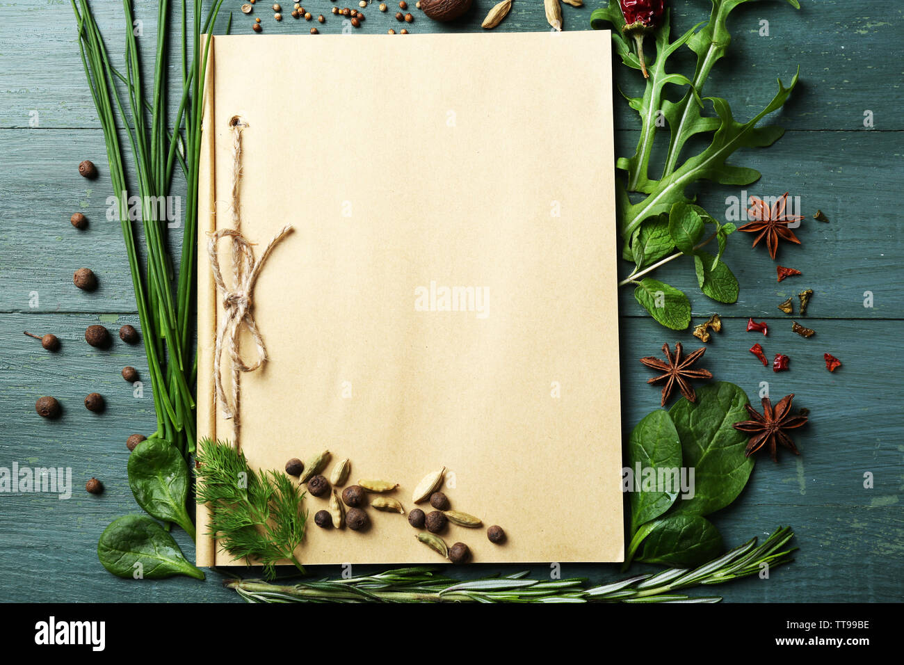 Open recipe book with fresh herbs and spices on wooden background Stock ...