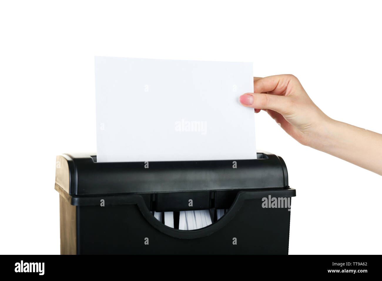 Female hand destroying sheet of paper with shredder isolated on white