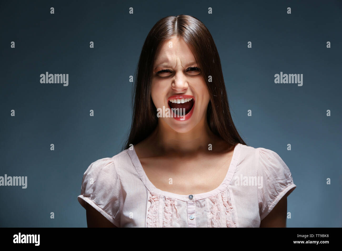 Portrait of beautiful young woman on dark background Stock Photo - Alamy