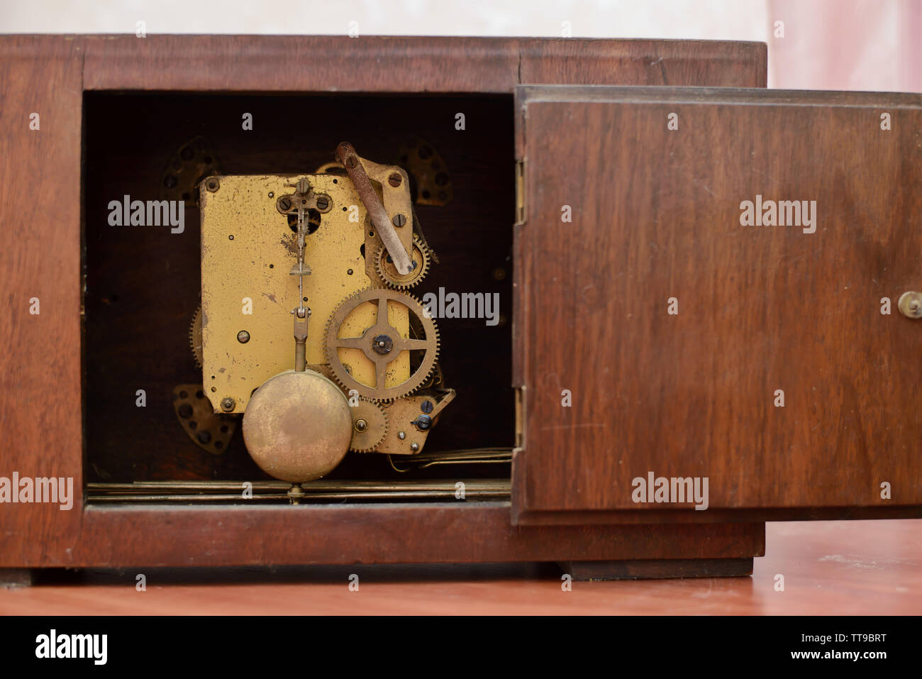 The mechanism of the old clock with the door open Stock Photo