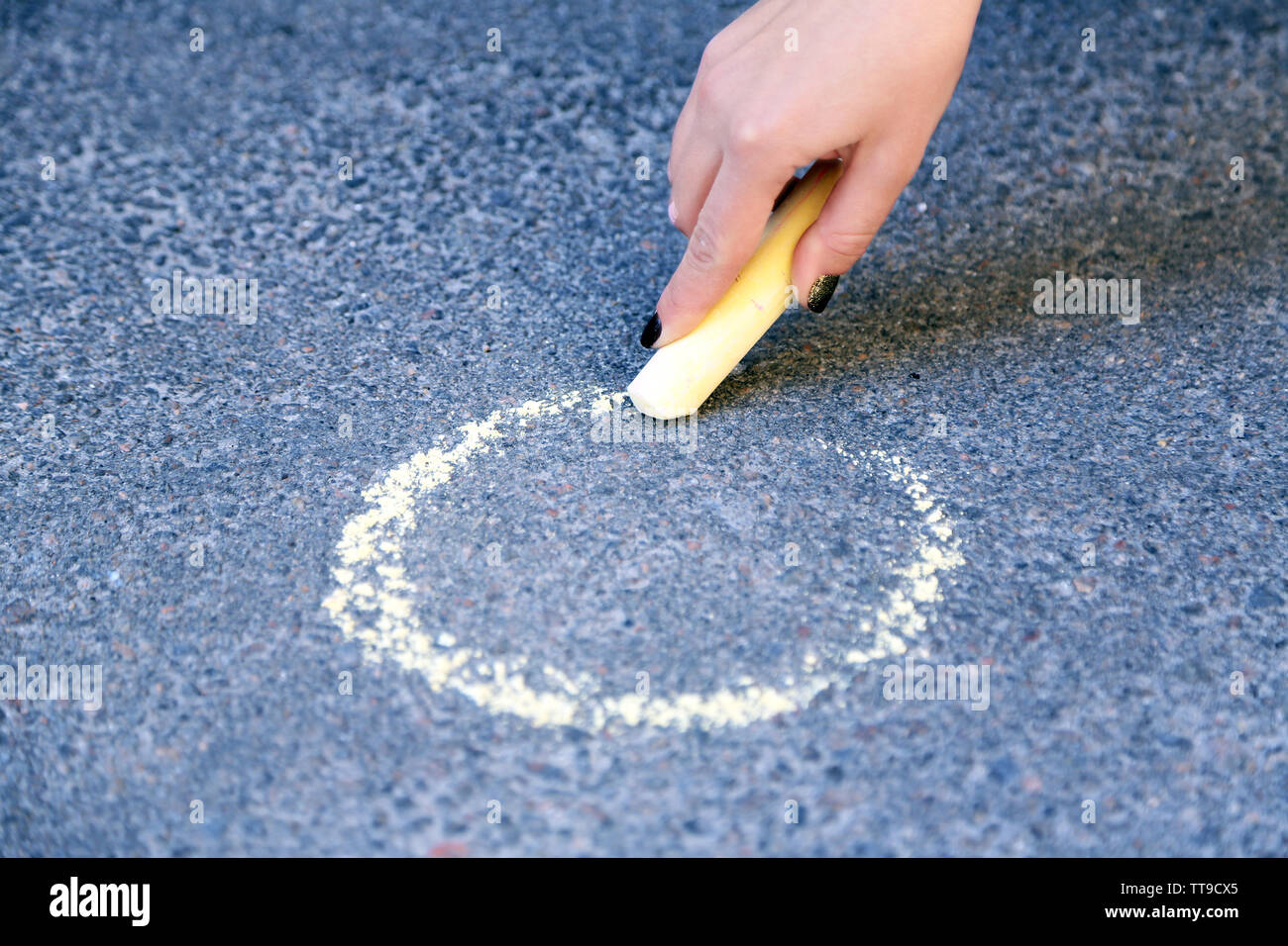 Girl drawing with chalk on asphalt Stock Photo - Alamy